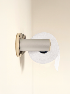 Top view of the checkerboard special-edition Roto holding a roll on a cream wall.